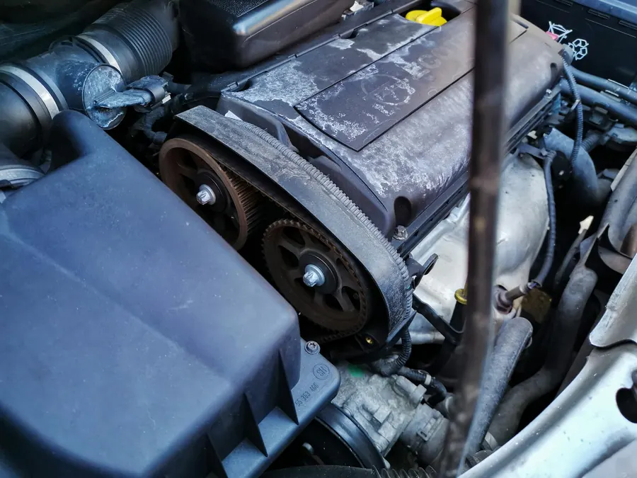 A timing belt inside an engine bay