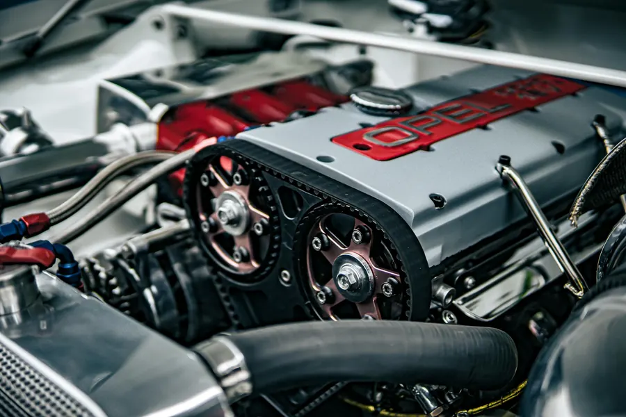 An engine with its timing belt and pulleys exposed