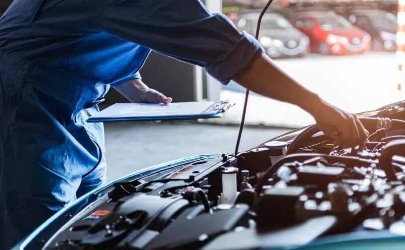A technician working in an engine bay